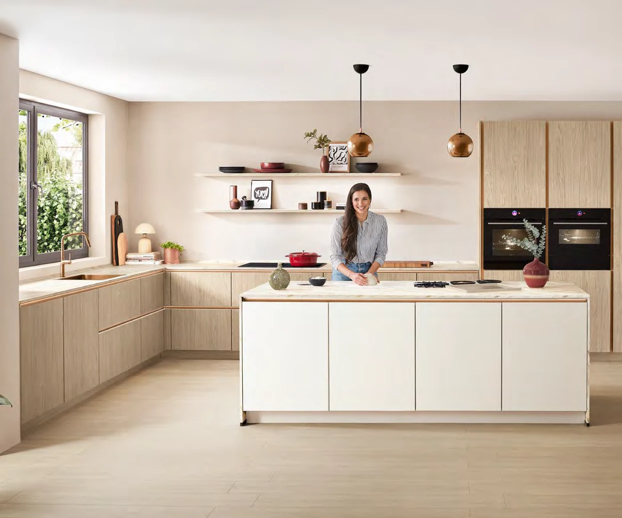 A person preparing food in a completed kitchen setting from the Kutchenhaus brochure
