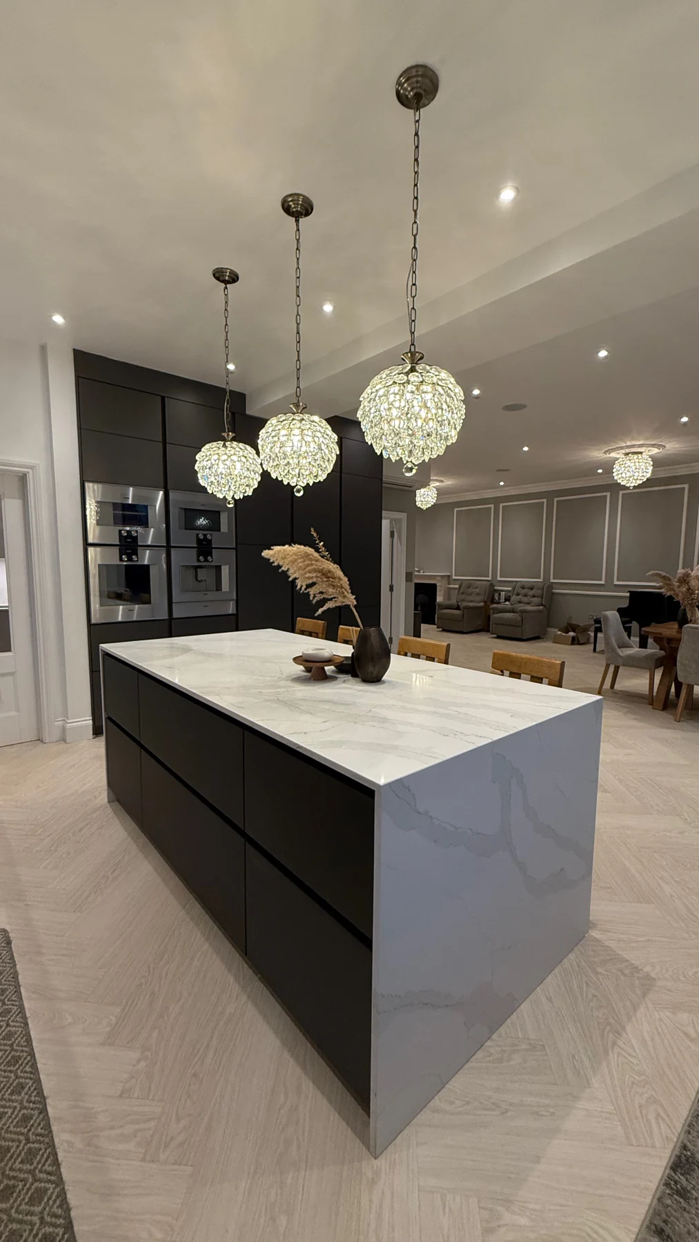 Calacatta Gold waterfall end wrapping the Artis Titanio kitchen island