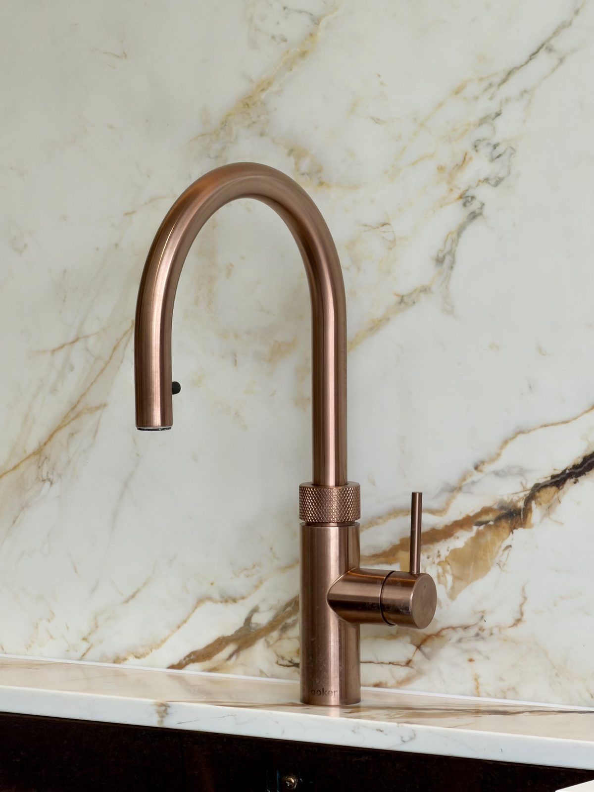Brushed copper tap on Calacatta